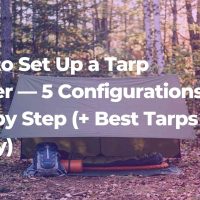 Perfectly pitched olive green A-frame tarp shelter between two birch trees in a forest clearing with backpack and sleeping mat underneath