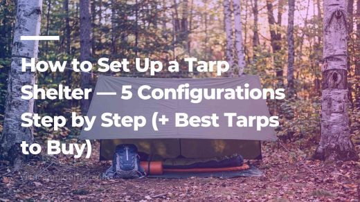 Perfectly pitched olive green A-frame tarp shelter between two birch trees in a forest clearing with backpack and sleeping mat underneath