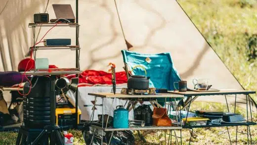 Common camping gear mistakes shown through a disorganized campsite with scattered equipment at dusk